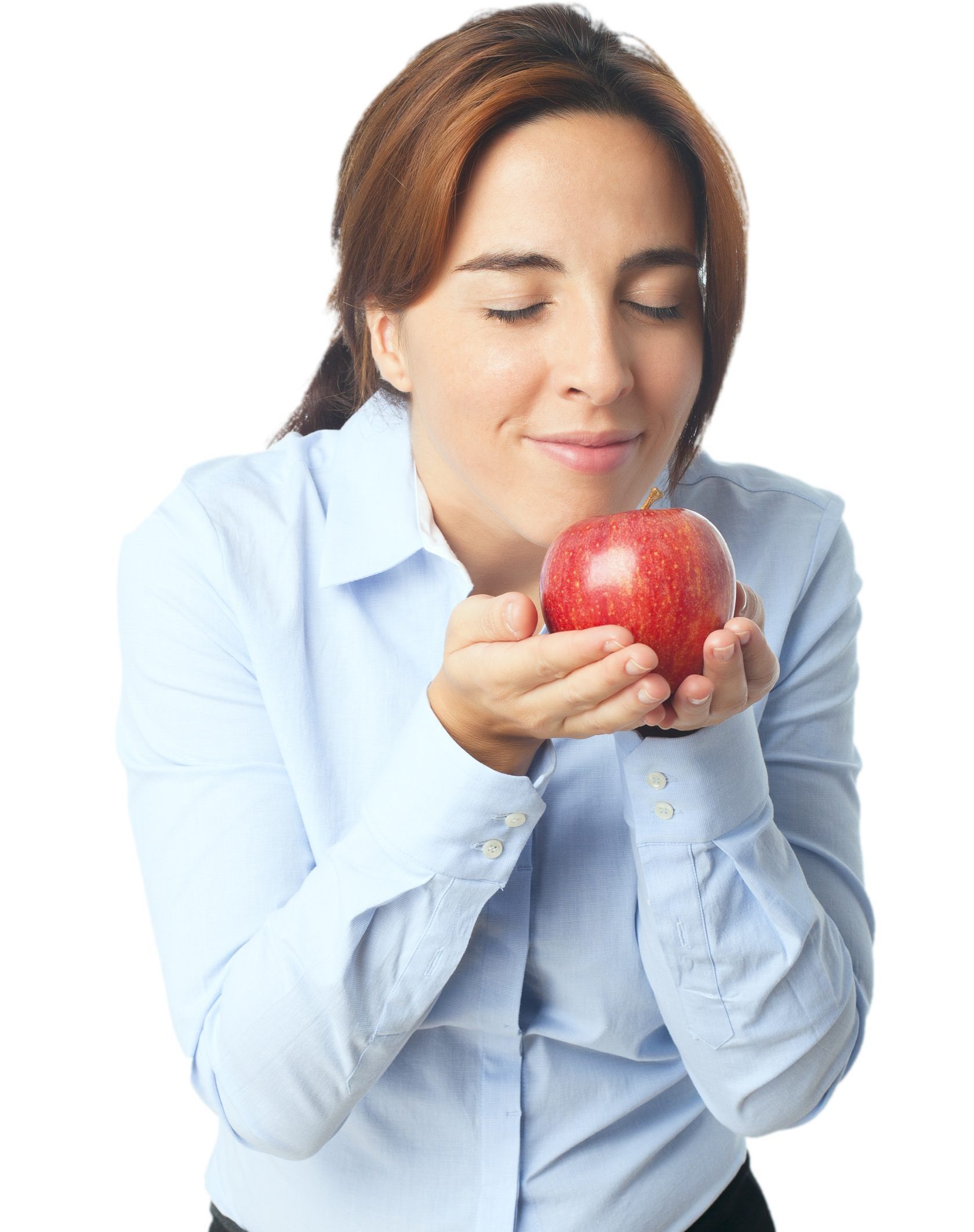 Smiling woman holding and smelling a fresh red apple with eyes closed