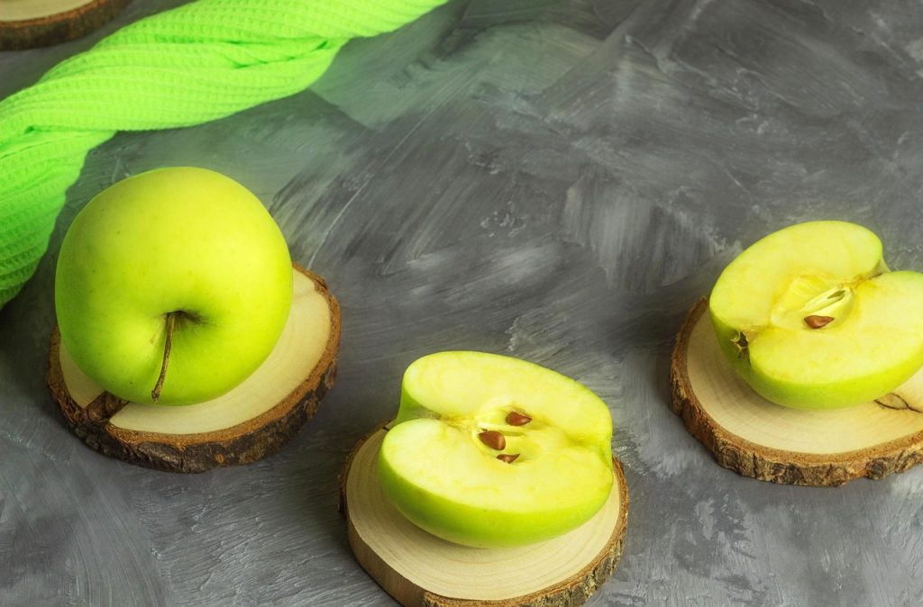 Healthy snack option with Granny Smith apple on a small wooden board