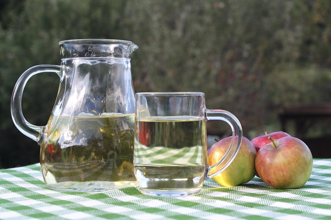 apple cider vinegar on table, near apples with it