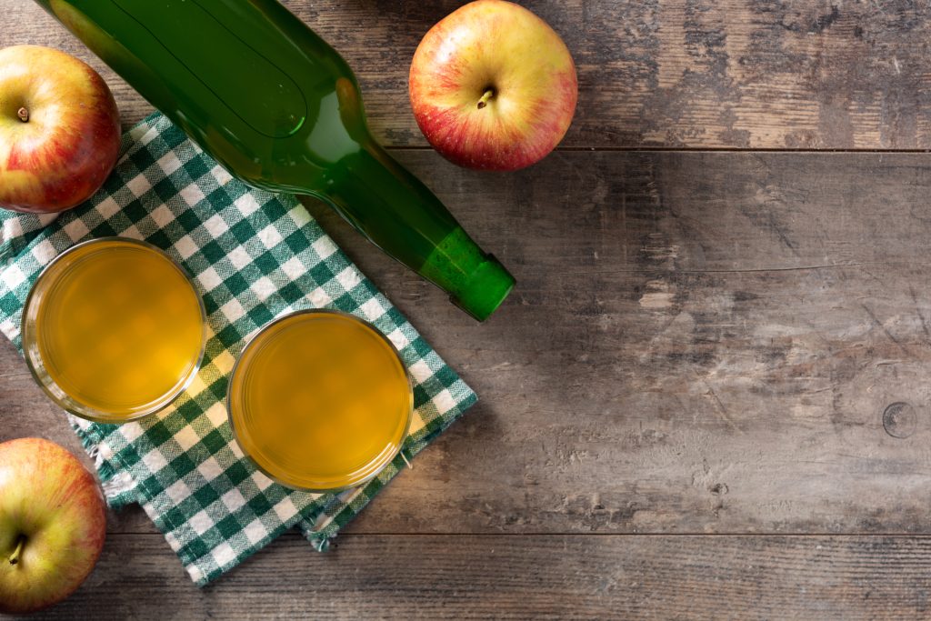 Apple cider drink on rustic wooden table