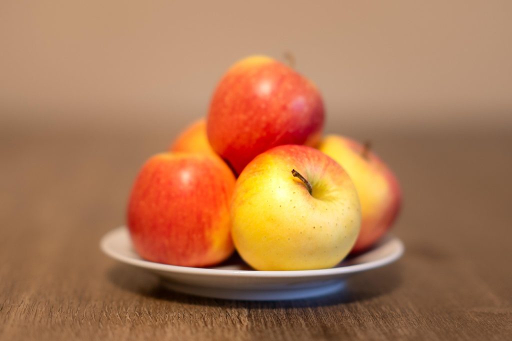 Honeycrisp apples in a white plate showing calorie and nutrition details